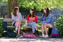 Students sitting on a bench outside