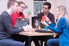Four students sitting at a table